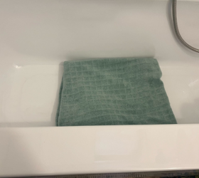 She lays a towel on the bottom of her bathtub for this clever trick