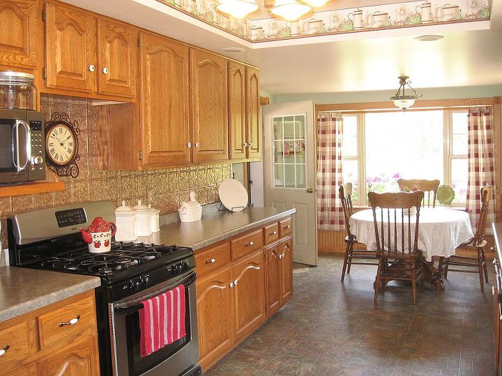 kitchen cupboards transformed, home decor, kitchen cabinets, kitchen design, painting, A before picture of our kitchen with cathedral style oak cabinets They just didn t fit our cottage and the kitchen was very dark however new ones weren t in the budget