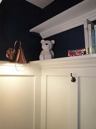 closet turned reading nook and toy storage, bedroom ideas, closet, lighting, shelving ideas, storage ideas, woodworking projects, Sconce added by running a cord around the molding and plugging it into the outlet outside the closet
