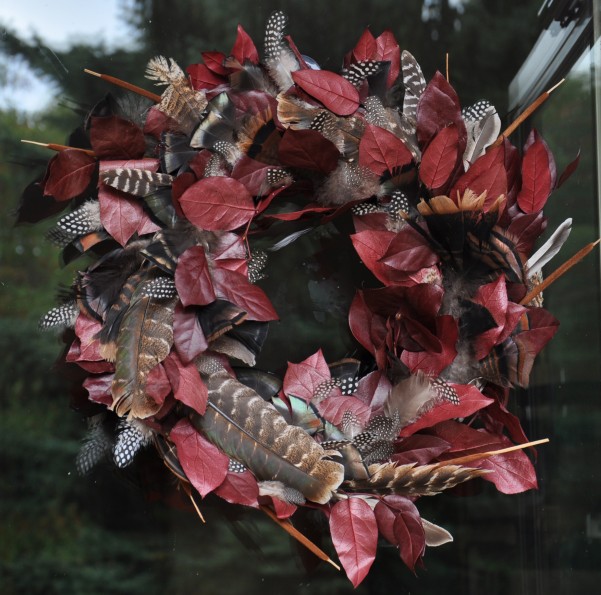 Beautiful DIY Thanksgiving wreaths adorned with autumn leaves, pumpkins, and berries.