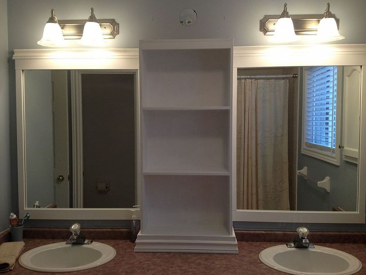 large bathroom mirror redo to double framed mirrors and cabinet, bathroom ideas, home decor, shelving ideas, bottom of cabinet dressed then realized I needed more height to cover the original light hole grrr