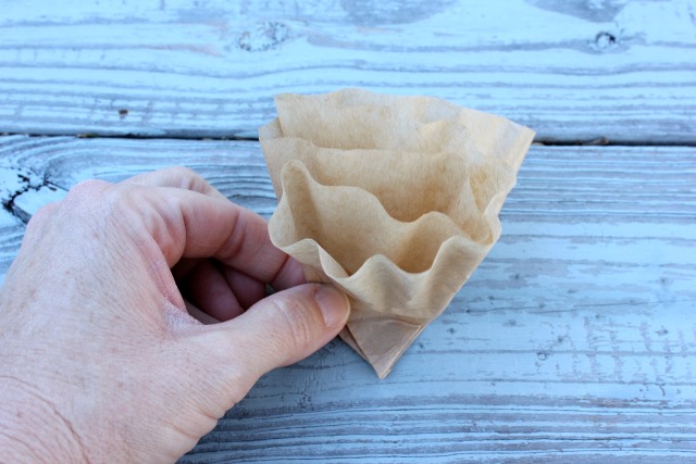 how to make a heart shaped coffee filter wreath, crafts, seasonal holiday decor, wreaths, Find the middle of the coffee filter and fold in half and back over You want the top to stay ruffly