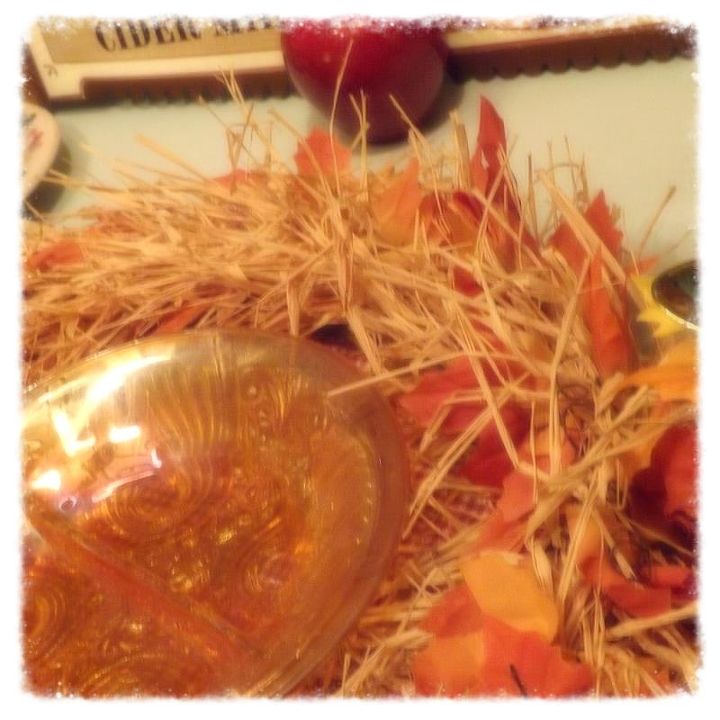 a fall table setting full of whimsy, home decor, A piece of caramel glass is sitting idle in the middle of a raffia leaf wreath just waiting to be filled with fresh watermelon