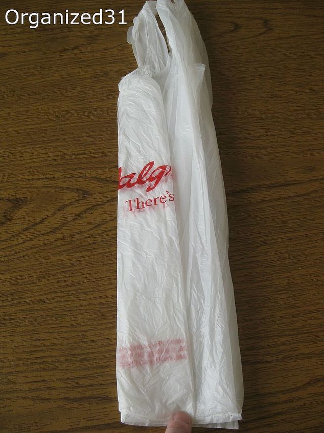 how to fold plastic shopping bags to take up less space, cleaning tips, Fold the bag in thirds