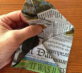 origami paper seedling pots from newspaper, Take the upper left corner and fold it straight across to meet the fold line half way above See black arrow in previous photo