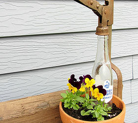 top flower junk garden posts 2012, container gardening, flowers, gardening, repurposing upcycling, succulents, In My First Garden Junk Planter of 2012 I display a terra cotta pot of violas with a vintage bottle and bottle capper