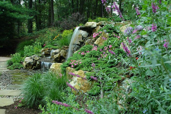 rotted retaining wall becomes and aquascape miracle project showcase how we went, decks, patio, ponds water features, pool designs, Newly landscape slope replaces old retaining wall Project by Deck and Patio Company Huntington Station New York Read more