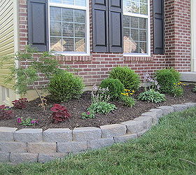 diy landscaping retaining wall, Retaining wall built with pavers The basic steps were to dig out the area add some sand to level the blocks Once they were all in place he added tiny pea gravel to help with drainage then filled it with topsoil until it was level with the rest of the ground