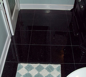spa blue bathroom makeover on a budget, bathroom ideas, home improvement, tiling, Here is the new blue butterfly black granite tile floor with black grout Added arctic white baseboard and trim to complete the look