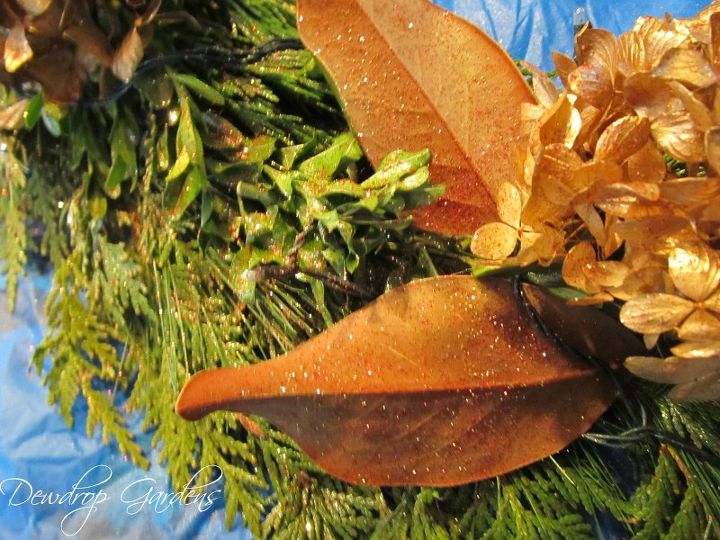 fresh greens wreath, christmas decorations, crafts, doors, seasonal holiday decor, wreaths, Magnolia leaves and gold spray painted hydrangea blooms all glittered up