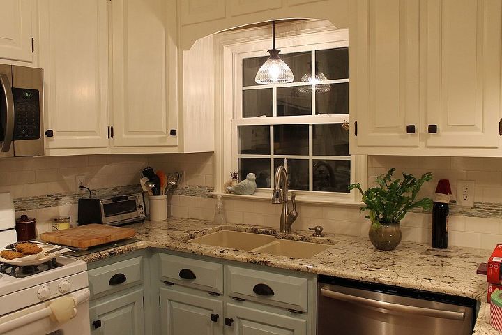 New cabinet design above the sink with a pendant light addition.