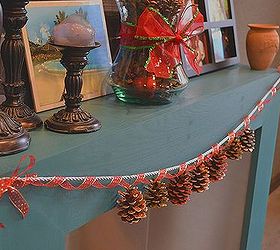 simple scented dazzling pine cone garland, crafts, seasonal holiday decor, I used a thick silver rope ribbon to hold the weight of the pine cones and then strung a gold and red ribbon around it to dress it up and add more depth