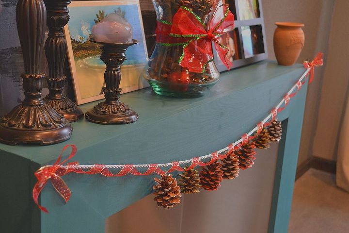 simple scented dazzling pine cone garland, crafts, seasonal holiday decor, I used a thick silver rope ribbon to hold the weight of the pine cones and then strung a gold and red ribbon around it to dress it up and add more depth