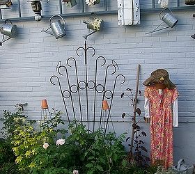 garden display ladder, gardening, repurposing upcycling, Create a hanging display for birdhouses and watering cans from a repurposed ladder See more of my ideas and projects at and