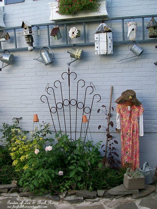 garden display ladder, gardening, repurposing upcycling, Create a hanging display for birdhouses and watering cans from a repurposed ladder See more of my ideas and projects at and