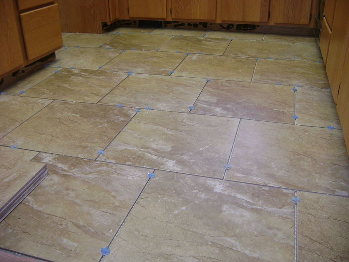 one broken piece of tile at a time this job took 5 days, bathroom ideas, kitchen design, tiling, 18x18 Porcelain tile stagger or brick lay pattern Kitchen