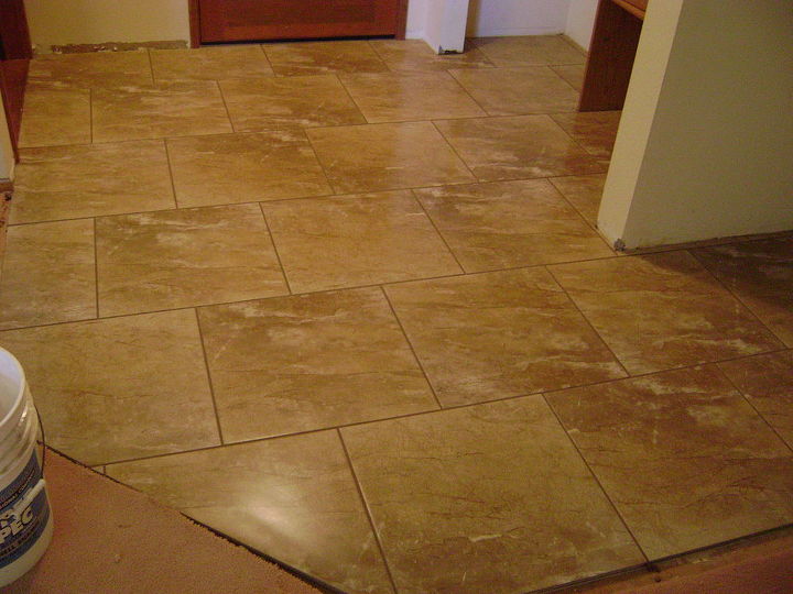 one broken piece of tile at a time this job took 5 days, bathroom ideas, kitchen design, tiling, 18x18 Porcelain tile stagger or brick lay pattern entry