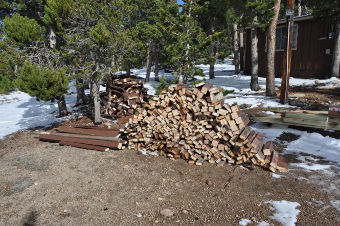 brian s deck, decks, some firewood in the foreground and waste pile in the way back