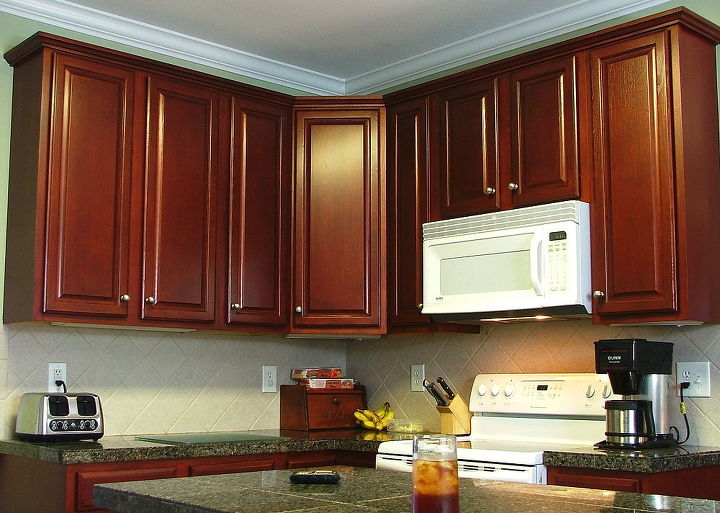 cathy saved 30 000 by refinishing her kitchen cabinets instead of replacing them, After Beautiful Cherry Finish