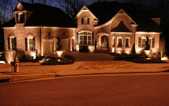 Front facade with landscape lighting accents.