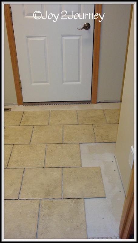 newly tiled mudroom floor and attached bathroom, flooring, laundry rooms, tile flooring, tiling, Laying tile in full tiles leaving the sides to cut all at once