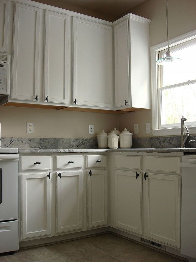 old oak cabinets painted white and distressed, white distressed cabinetry make the kitchen look brand new