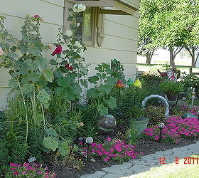 flower beds, flowers, gardening, removed rock and made an expanded flower bed along the garage