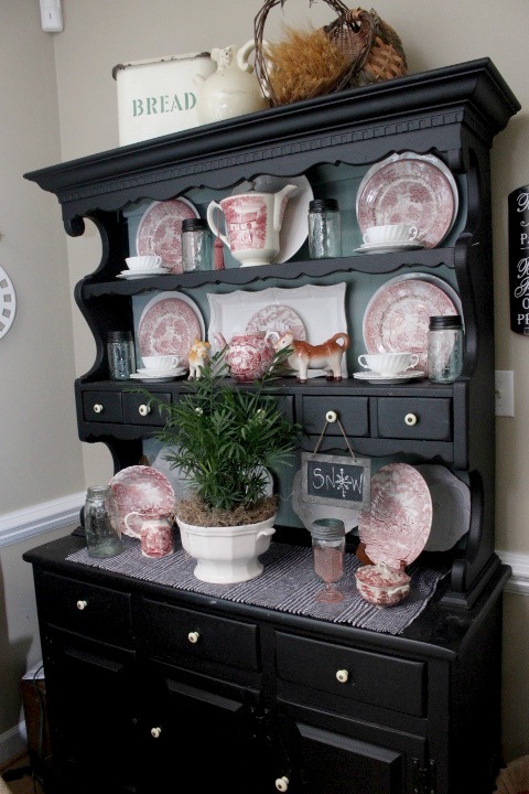 creating a cozy sitting area from another space for virtually free, home decor, living room ideas, painted furniture, I kept the pink and white transferware in black painted hutch and added a 5 96 Thrift store white ironstone soup tureen filled with a 5 plant