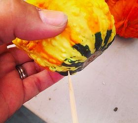 using gourds in your fall planters, gardening, seasonal holiday decor, All you need to do is poke a skewer in the bottom to turn the gourd into a planter pick