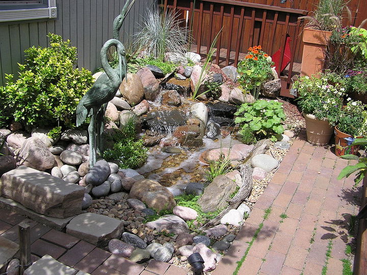 pondless waterfalls work well when space is at a premium, ponds water features, urban living, A small pondless waterfalls livens up this Denver Colorado backyard The yard is small and narrow behind a century old Victorian home but has enough room to add a beautiful water feature