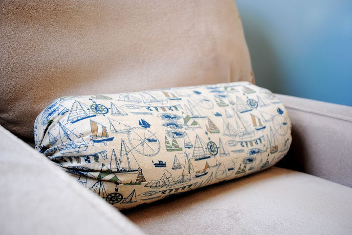 the nautical nursery that changed our lives, bedroom ideas, home decor, Pillows such as this sailboat bolster add to the look without going overboard wink