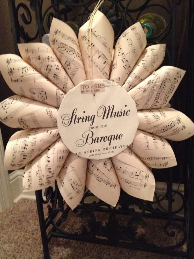 vintage sheet music wreaths, crafts, repurposing upcycling, the back of a wreath I poke a hole and loop the string or ribbon through before adding cones Saves some time and aggravation