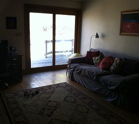 please help with furniture placement ideas, Sorry it is so dark the couch is along the wall that has the cellar door on it to the right of the couch and the french doors lead out onto the deck We have tried putting curtains on the door but the dog disrupts them
