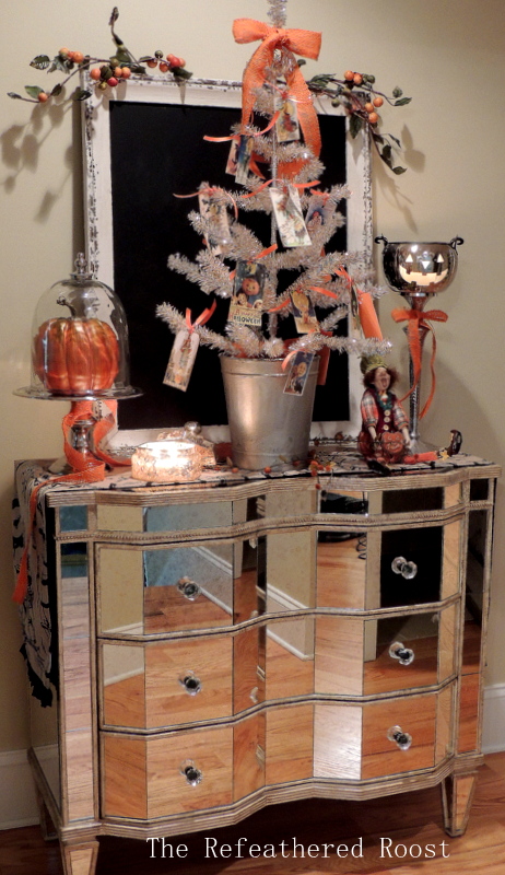 vintage halloween tree, halloween decorations, seasonal holiday d cor, A vintage Halloween display on Mirrored Piece to highlight the silver and orange color scheme