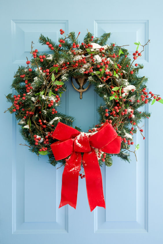 should you list your home for the holidays yes but keep the decorations simple and, fireplaces mantels, real estate, seasonal holiday d cor, wreaths, A simple holiday wreath on the front door says instantly welcome