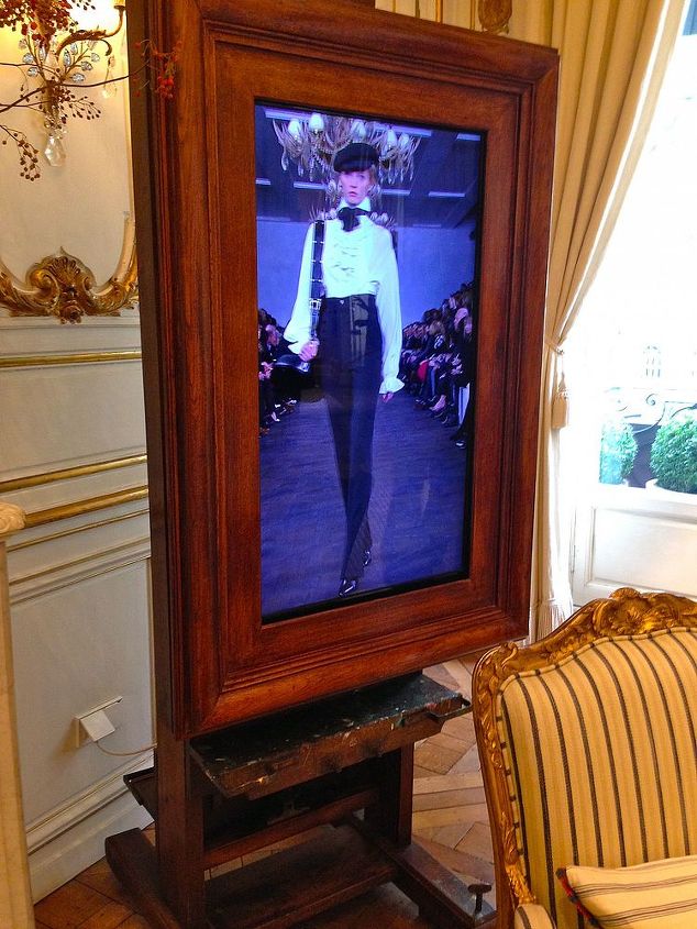 make a television stand from an artist s easel, diy renovations projects, repurposing upcycling, A television rests perfectly on this artist antique easel It is the best television stand I have ever seen