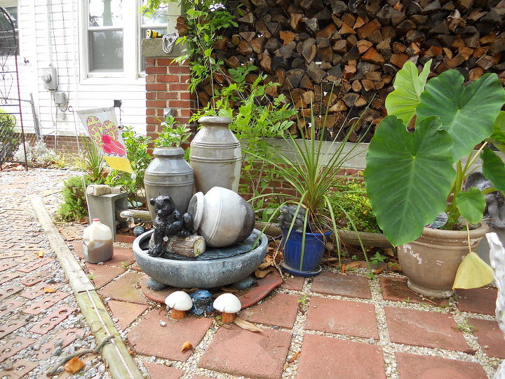 our courtyard in bloom, decks, flowers, outdoor living, A fountain offers soothing sounds to our courtyard You probably can t see the cute little spitting turtle hiding in the flowerpot beside the fountain but he s there