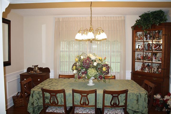 family pictures in the dining room, dining room ideas, home decor, This is a shot of the room as a whole As you can see I have a Santa collection in the corner cabinet which I really would like to move it elsewhere if I had the room Also upholstery on the chairs are going to be changed Suggest