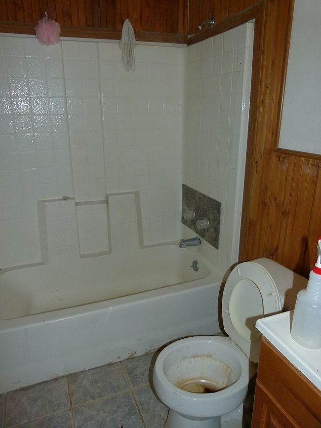 bathroom remodel, bathroom ideas, home improvement, BEFORE Nasty the tub had been plumbed by a dummy see the formica piece covering their huge hole obviously they didn t know how to measure for their cuts