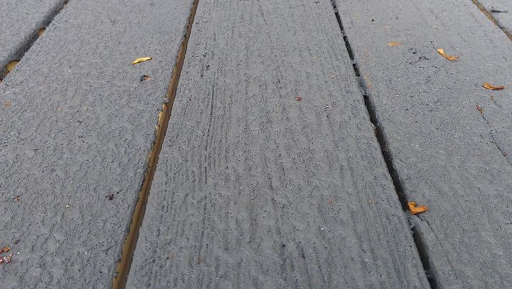 a restored deck with restore deck armour, decks, A closeup view of one coat on aged PT lunber