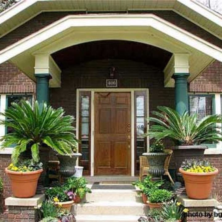 small porch pizzazz, curb appeal, outdoor living, porches, Stately plantings enhance this small bungalow porch Photo courtesy of buyamac on Flickr