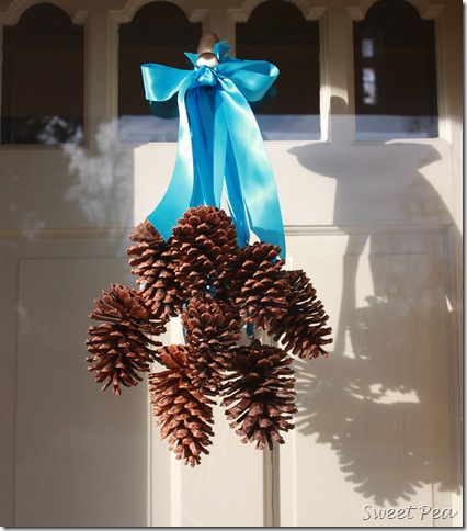 pine cone door decoration, crafts, seasonal holiday decor, Pine cones hanging from individual ribbons make a pretty winter door decor