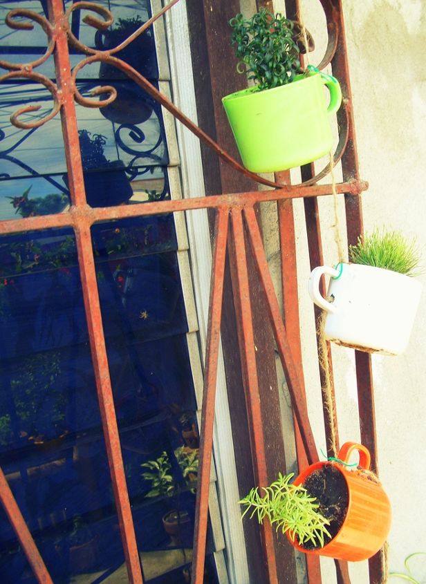 old chipped plastic cups repurposed as hanging planters, gardening, repurposing upcycling