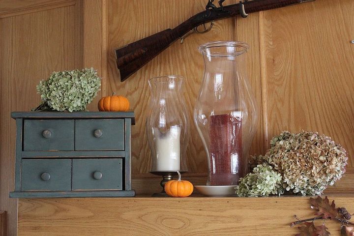natural materials decorate small house thanksgiving mantle, seasonal holiday d cor, thanksgiving decorations, wreaths, Colonial candle box colonial black power gun set the scene for our primitive vintage fireplace look