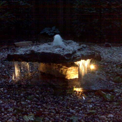 underwater lighting creates a nighttime oasis for water feature owners, landscape, lighting, outdoor living, ponds water features, Accent lights are great for Water Features such as this stone bubbler