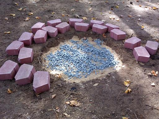 brick backyard firepit, leveled the ground and filled with small amount of sand then gravel
