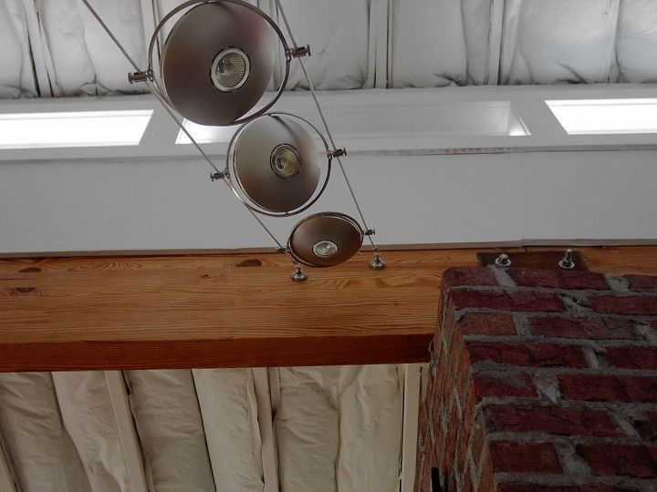 replaced existing wall mounted fixture with suspended low wattage spot fights, Upper anchors not level see notes in wood laminate beam