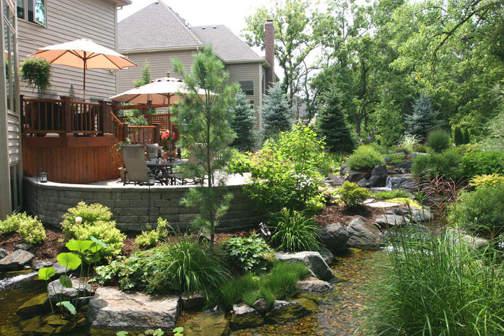 create a tropical dining spot in your backyard, decks, gardening, outdoor living, patio, ponds water features, Deck and patio are hugged by a stream like waterfall