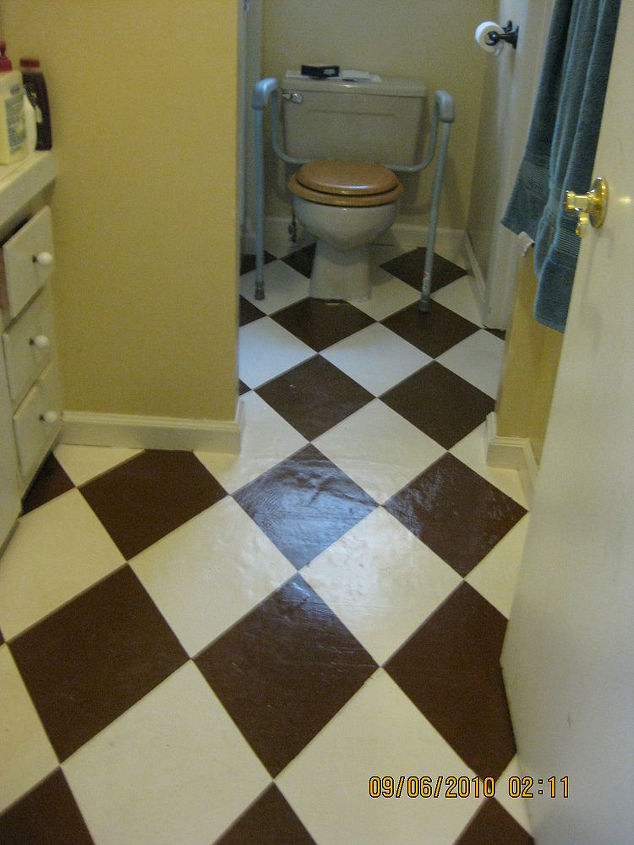 farmhouse bathroom floor, Floor with three coats of Milk Chocolate paint and all the yellow tape peeled away I ll go back at a later date to paint small diamonds at the intersection of the large diamonds using a third intermediate color