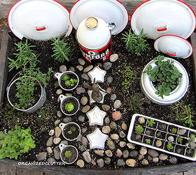 another kitchen fairy garden, gardening, I used an ice cube tray jello molds a Rumford baking powder tin funnel measuring cups and old pot lids The fence is butter knives All vintage